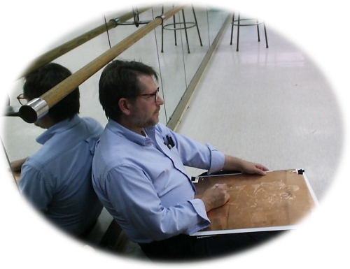 Artist B. H. Giza working on a drypoint in a ballet class